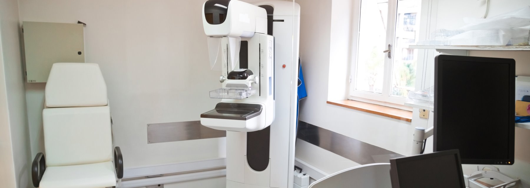 A medical examination room equipped with a computer and a chair at Kilmore Eye Associates